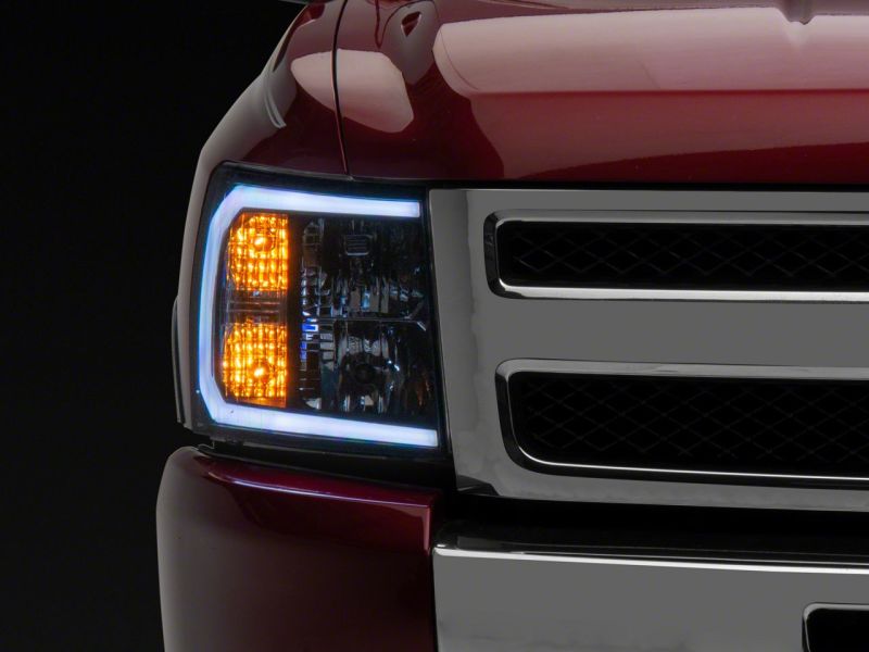 Raxiom 07-13 Chevrolet Silverado 1500 Axial Headlights w/ SEQL LED Bar- Black Housing (Clear Lens)