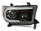 Raxiom 07-13 Toyota Tundra Axial Projector Headlights w/ SEQL LED Bar- Black Housing (Clear Lens)