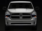 Raxiom 09-18 Dodge RAM 1500/2500/3500 Axial Headlights w/ SEQL LED Bar- Black Housing (Clear Lens)
