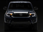 Raxiom 12-15 Toyota Tacoma Axial Projector Headlights w/ SEQL LED Bar- Black Housing (Clear Lens)