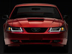 Raxiom 99-04 Ford Mustang Axial Series Headlights w/ LED Bar- Black Housing (Clear Lens)